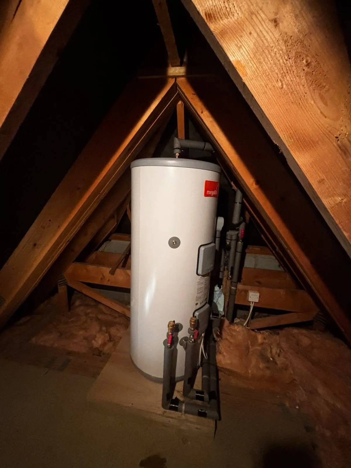 Megaflo unvented cylinder on its new plywood and timber base in a Petersfield loft